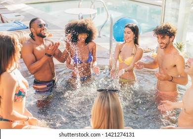 Multiethnic Group Of Young People - Mixed Race Best Friends Having Fun In Jacuzzi - Generation Z Students Summer Crazy Pool Party - Rich Kids Hanging Out Concept