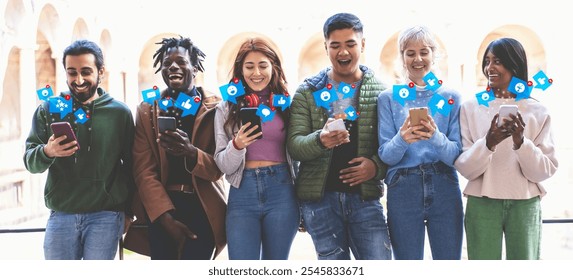 Multiethnic group of young people using smartphones outdoors, sharing social media content with excited expressions during sunny day