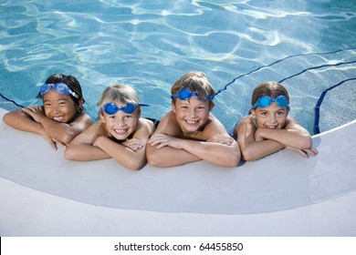 Multi-ethnic kids, relaxing in a row on side of swimming pool, ages 7 to 9