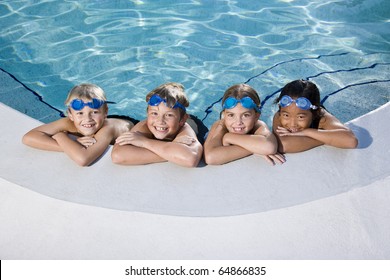 Multi-ethnic kids, relaxing in a row on side of swimming pool, ages 7 to 9 - Powered by Shutterstock