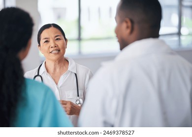 Multi-Ethnic Medical Team Discussing Patient Care in Hospital Setting - Powered by Shutterstock