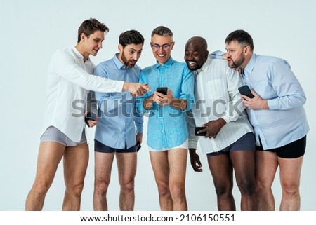 multiethnic men posing for a male edition body positive beauty set.  guys with different age, and body wearing boxers underwear and shirt