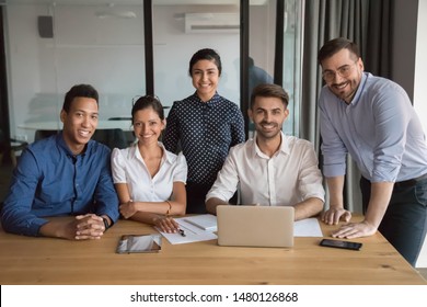 Multi-ethnic millennial employees company members different ethnicity international corporate department photographed in office. Career and leadership, portrait of successful motivated team concept
