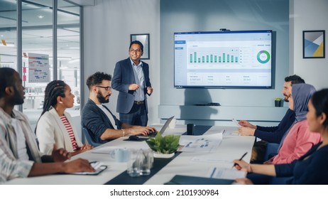 Multi-Ethnic Office Conference Room. Brilliant Indian Male CEO does Presentation for Multi-Ethnic Group of Managers Talking, Using TV Infographics, Statistics, Graphs. Innovative Businesspeople - Shutterstock ID 2101930984