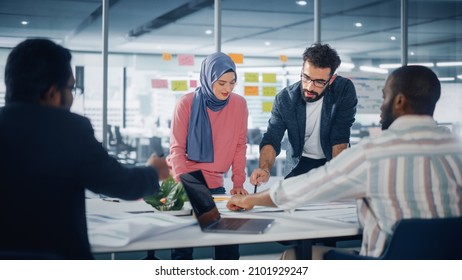 Multi-Ethnic Office Conference Room Businesspeople Meeting at Big Table. Diverse Team of Creative Entrepreneurs Talk, Use Laptop. Specialists work in Digital e-Commerce Startup. - Shutterstock ID 2101929247