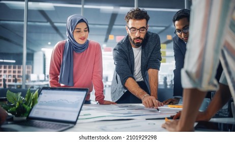 Multi-Ethnic Office Conference Room Businesspeople Meeting Gather Around Table. Diverse Team of Creative Professionals Talk, Brainstorms, work in Innovative Digital e-Commerce Startup. - Powered by Shutterstock