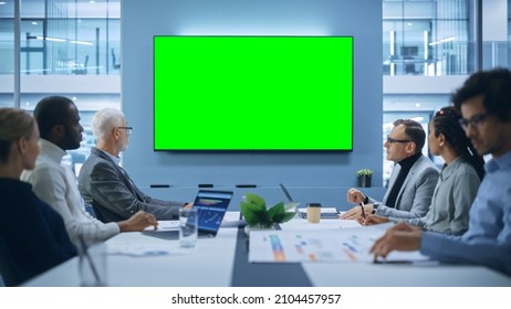 Multi-Ethnic Office Conference Room Meeting: Diverse Team of Successful Managers, Executives Talk, Use Green Screen Chroma Key TV. Group of Businesspeople Work on Strategy for an e-Commerce Startup - Powered by Shutterstock