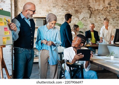 Multi-Ethnic Office Workspace Room - Businesspeople Meeting Gather Around The Business Model Canvas - Diverse Team Of Creative Professionals Talk, Brainstorms, Work In Innovative Digital Startup.