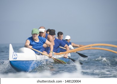Multiethnic outrigger canoeing team in race