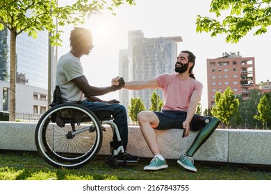 Multiethnic people with disabilities greeting each other outdoor - Focus on right man with leg prosthesis - Powered by Shutterstock