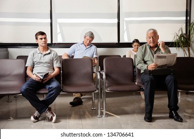 Multiethnic People Waiting For The Doctor In Hospital Lobby