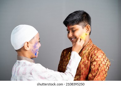 Multiethnic Religious Kids Celebrating Holi By Applying Colors To Face On Gray Background - Concept Of Cultural Festivals, Friendship And Unity In Diversity