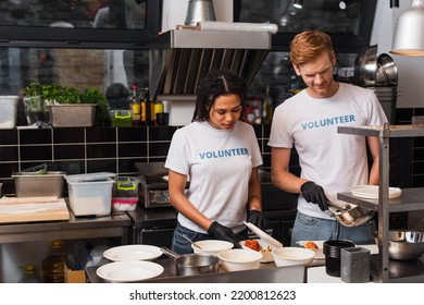 Multiethnic Social Workers In Latex Gloves Putting Prepared Food Into Plastic Containers