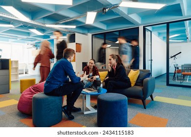 Multiethnic startup business team on meeting in a modern bright open space coworking office. Brainstorming, working on laptop. Group of coworkers walking around in motion blur - Powered by Shutterstock