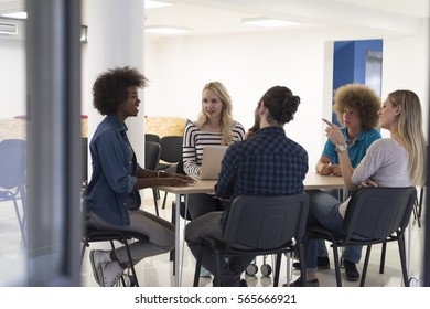 Multiethnic startup business team on meeting in modern bright office interior brainstorming, working on laptop and tablet computer - Shutterstock ID 565666921