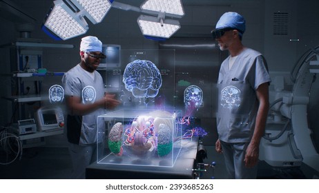 Multiethnic surgeons work in operating room wearing AR headsets, using holographic display. 3D graphics of virtual human skeleton, organs and vital signs. AI technology in medicine. High-tech surgery. - Powered by Shutterstock