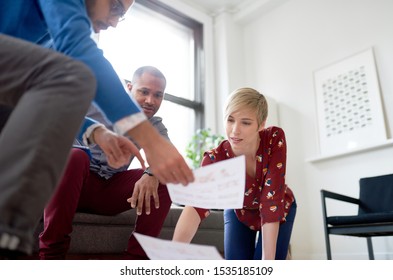 Multi-ethnic team of creative millenials collaborating on a brai