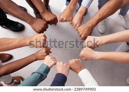 Multi-Ethnic Team Embraces Unity with Racial Fist Huddle