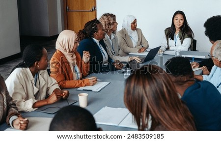 Similar – Image, Stock Photo A focused group of people in casual sportswear engage in stretching exercises before starting their outdoor basketball session