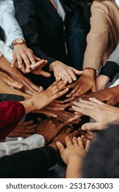 Multiethnic teamwork with diverse hands working together, representing unity and collaboration in a group setting. This image captures a sense of unity, diversity, and collective effort.