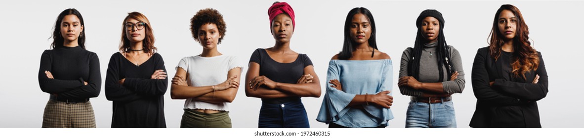 Multiethnic women standing together with arms crossed. Strong young women with diverse ethnicities. - Shutterstock ID 1972460315