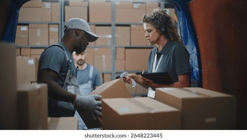 Multiethnic Workers Unloading Cardboard Boxes with Online Orders, E-Commerce Goods from Delivery Truck. Female Manager Using Tablet Computer and Barcode Scanner. Outside of Logistics Retail Warehouse.