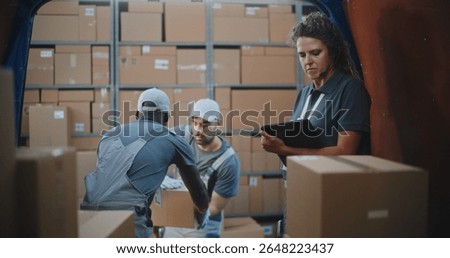 Multiethnic Workers Unloading Cardboard Boxes with Online Orders, E-Commerce Goods from Delivery Truck. Female Manager Using Tablet Computer and Barcode Scanner. Outside of Logistics Retail Warehouse.