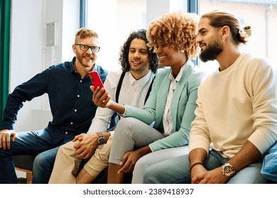 Multi-ethnic young people using mobile sitting on a coworking