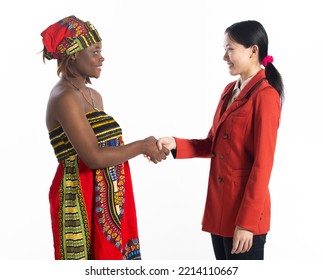 Multiethnic Young Women Shake Hands Together, Business Woman Smile Positive Expressions. Multiracial African Woman, Asian Female, Two Persons, Racial Unity Business Concept. White Background Isolated