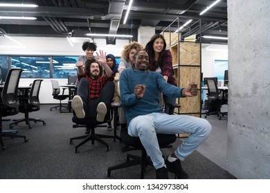 multiethnics startup business team of software developers having fun while racing on office chairs,excited diverse employees laughing enjoying funny activity at work break,  - Shutterstock ID 1342973804