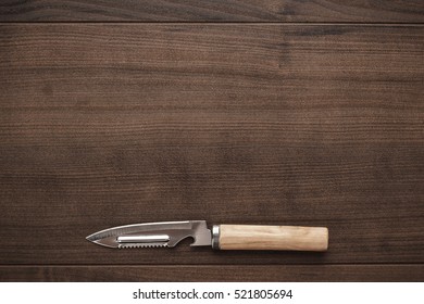 Multifunctional Kitchen Knife On The Wooden Table