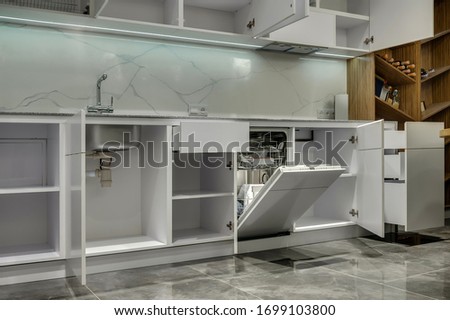 Multifunctional modern kitchen. Opened cabinets and drawers