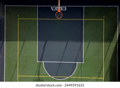 multifunctional outdoor playground  ball games school. green artificial turf from  plastic carpet with lines. basketball hoops and soccer goals. around the grabbing high net and guardrails, yellow
 - Powered by Shutterstock