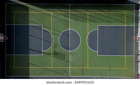 multifunctional outdoor playground  ball games school. green artificial turf from  plastic carpet with lines. basketball hoops and soccer goals. around the grabbing high net and guardrails, yellow
 - Powered by Shutterstock