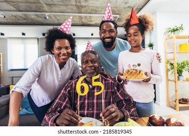 Multi-Generation african american family celebrating grandfathers birthday at home together - Powered by Shutterstock