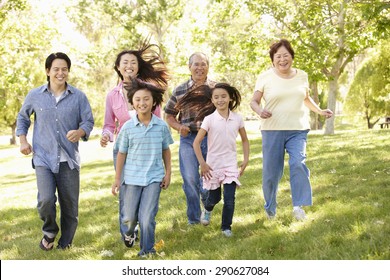 Multi-generation Asian Family Running In Park