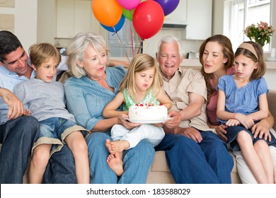 Multigeneration family celebrating girls birthday at home - Powered by Shutterstock