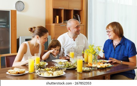  Multigeneration Family  Eating Fish With Vegetables At Home Together