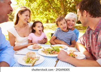 Multi-generation Family Eating Together Outdoors