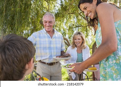 Multi-Generation Family Enjoying Barbeque By Lake - Powered by Shutterstock