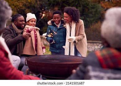 Multi-Generation Family Having Fun With Firework Sparklers In Autumn Garden Together - Powered by Shutterstock