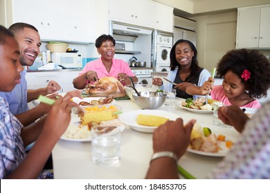 Multigeneration Family Sitting Around Table Eating Stock Photo ...