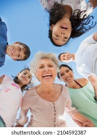 Multi-generation Family Smiling In Huddle