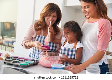 Multi-Generation Hispanic Female Family Having Fun In Kitchen At Making Cake Together - Powered by Shutterstock