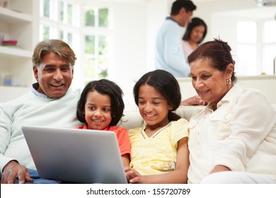 Multi-Generation Indian Family With Laptop