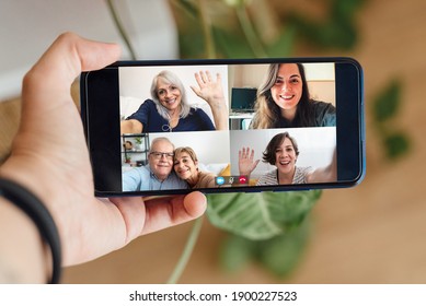 Multigeneration people having video call with mobile phone during lockdown isolation - Social distance concept - Powered by Shutterstock