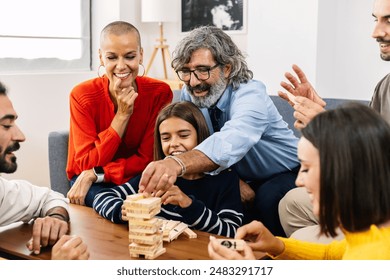 Multigenerational caucasian family having fun playing together at home, sitting together on sofa in living room. - Powered by Shutterstock