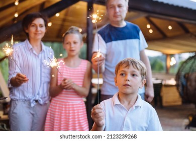 Multigenerational Family Celebrating With Sparkles At Backyard.