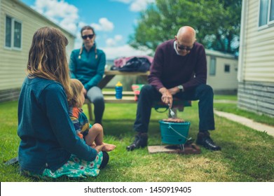 A Multigenerational Family Is Enjoying A Barbecue In The Trailer Park