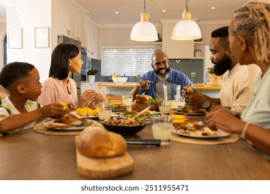 multigenerational family enjoying dinner together, sharing stories and bonding at home table. togetherness, meal, indoors, happiness, lifestyle - Powered by Shutterstock